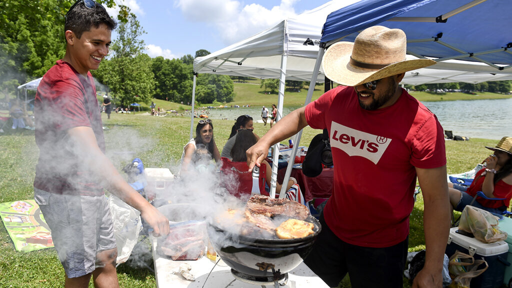 Bern twp., PA – July 4: Paulo Rodredo, left, and Ney Santos, right, of Philadelphia, at the grill Saturday afternoon. At the Blue Marsh Lake Dry Brooks