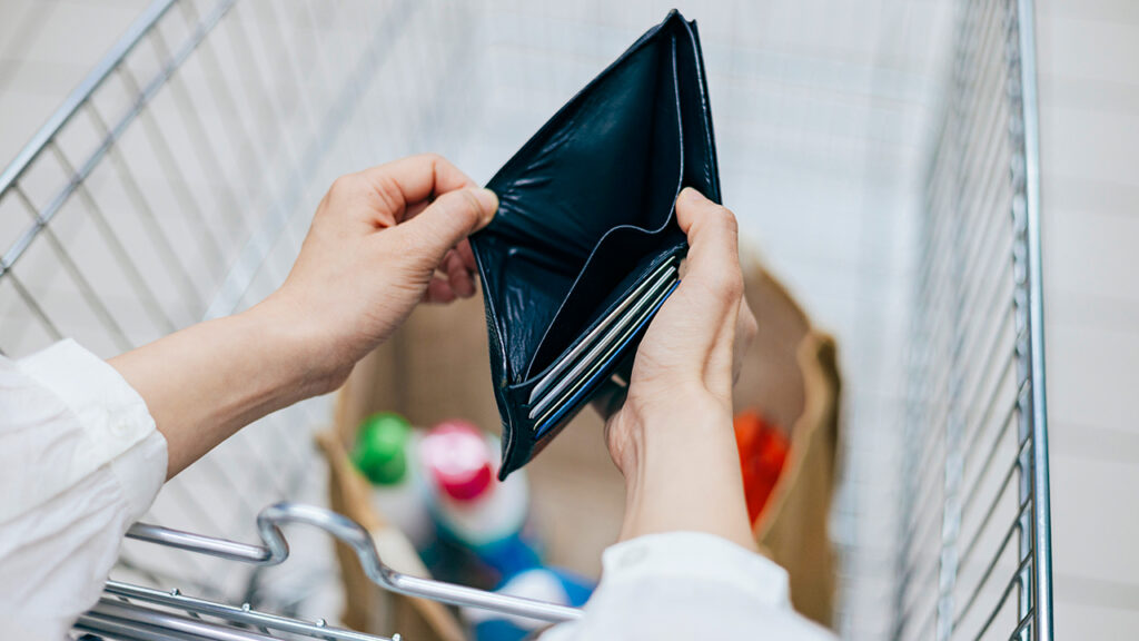 Woman holds empty wallet